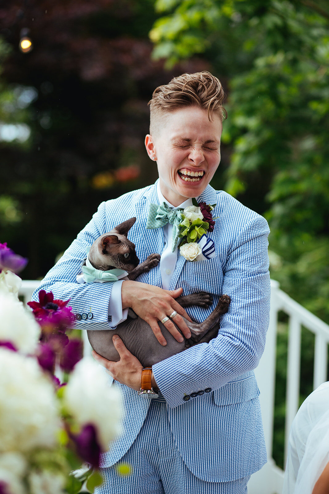Newlywed laughing and holding pet cat in Annapolis MD Shawnee Custalow Photography