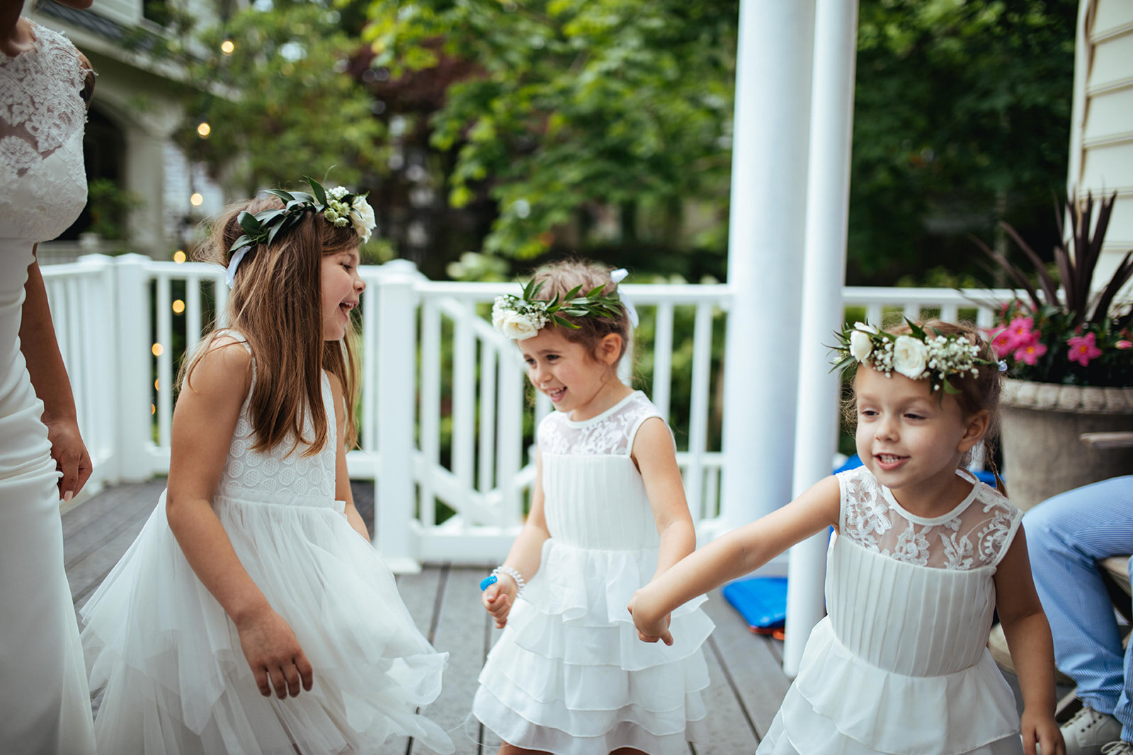 Flower girls dancing in floral headbands and white dresses in Annapolis MD Shawnee Custalow