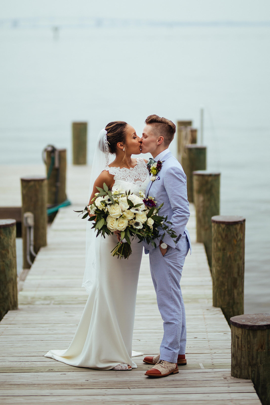LGBTQ newlyweds kissing by the Chesapeake Bay in Annapolis MD Shawnee Custalow Photography