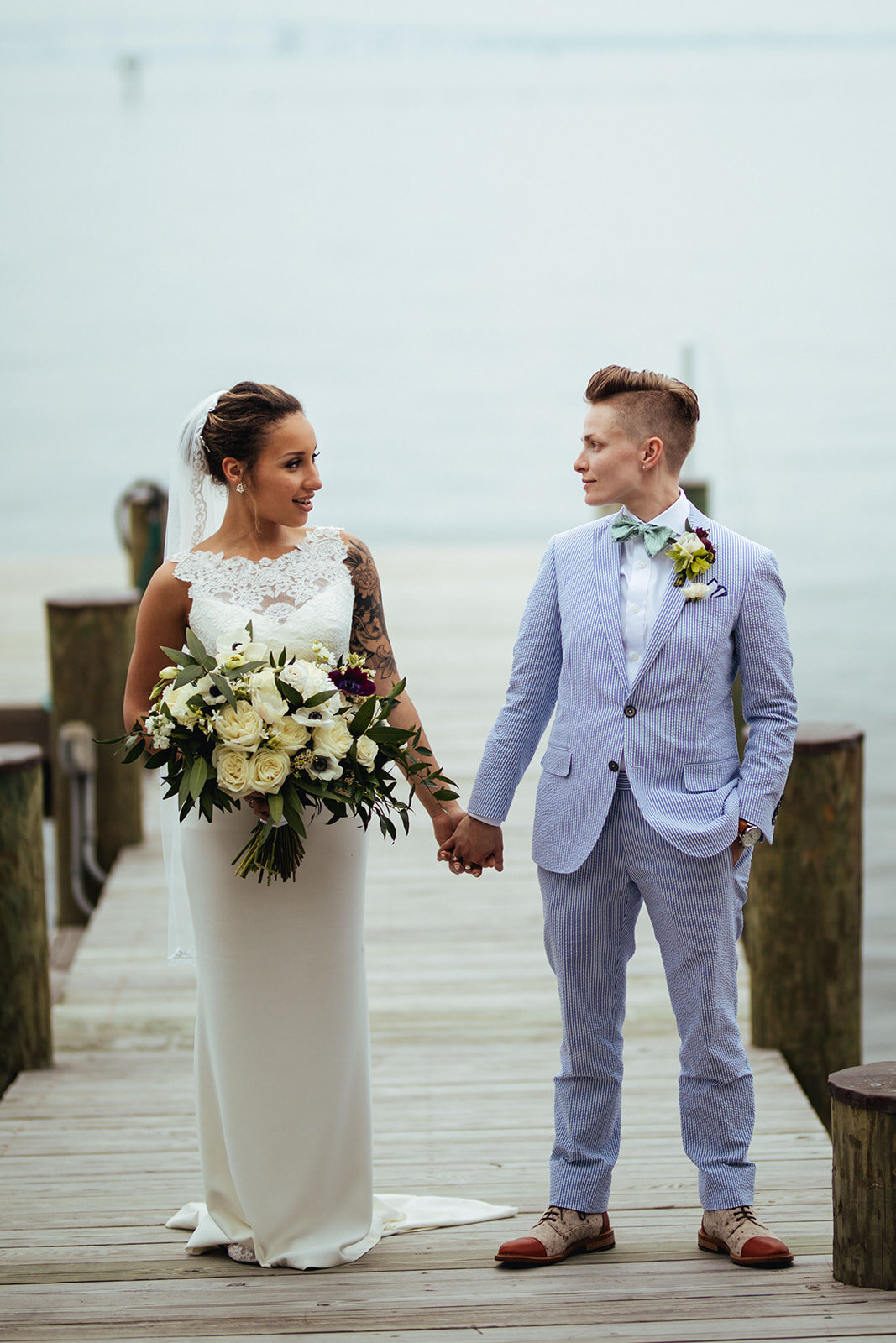 Newlyweds holding hands by the Chesapeake bay in Annapolis MD Shawnee Custalow Photography