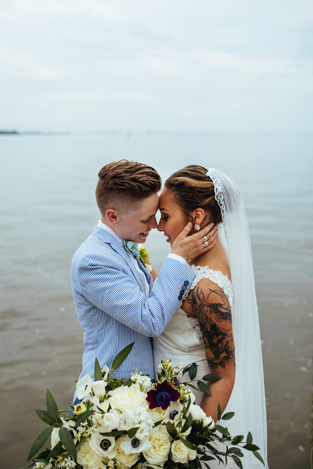 Newlyweds leaning in for a kiss by the Chesapeake Bay in Annapolis MD Shawnee Custalow Photography
