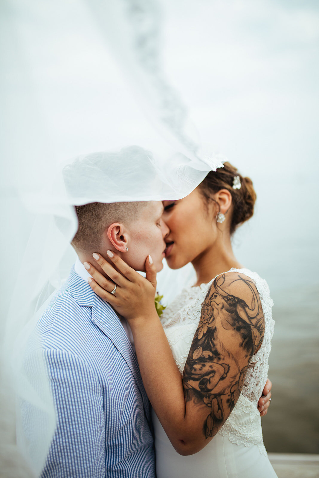 Newlyweds kissing under a veil by the Chesapeake Bay MD Shawnee Custalow Photography