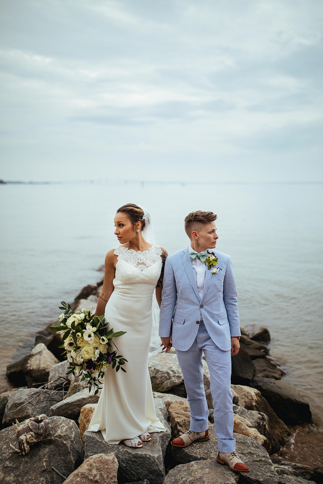 LGBTQ newlyweds on rocks along the Chesapeake Bay Shawnee Custalow Wedding Photography