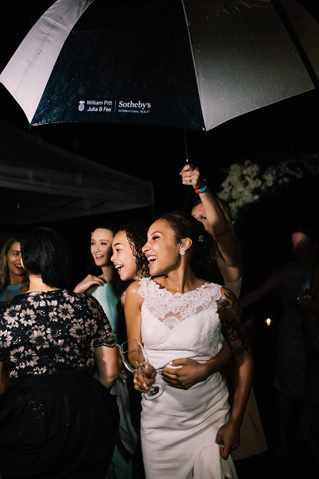 Bride dancing with guests under an umbrella in Annapolis MD Shawnee Custalow Photography