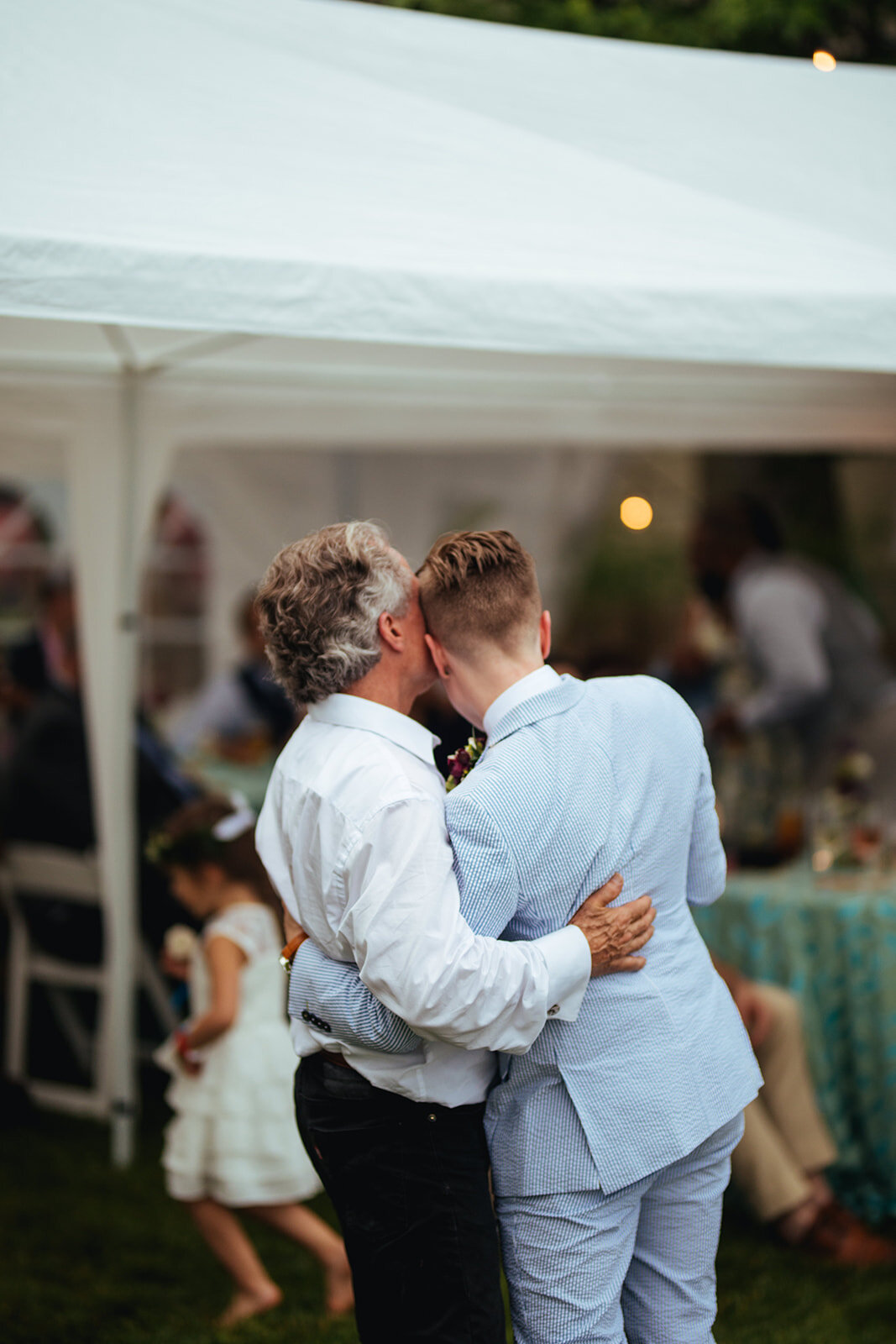 Newlywed embracing father at Annapolis wedding reception MD Shawnee Custalow Photography