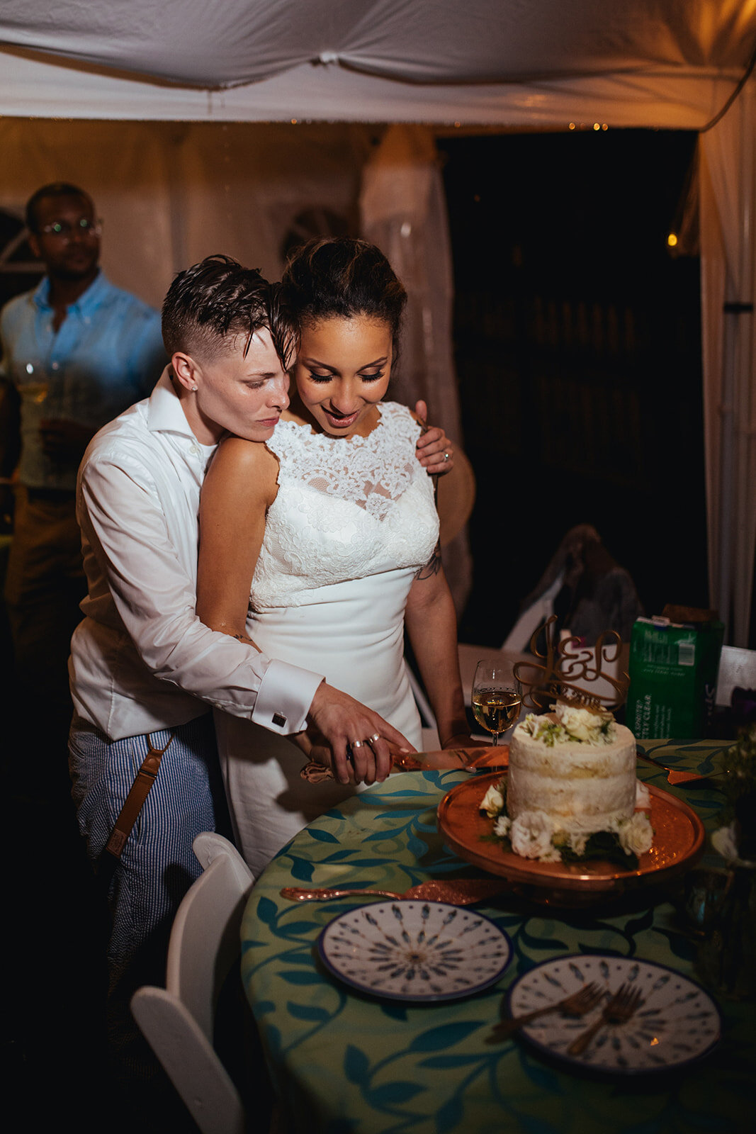 Newlyweds cutting the cake in Annapolis MD Shawnee Custalow queer wedding Photography
