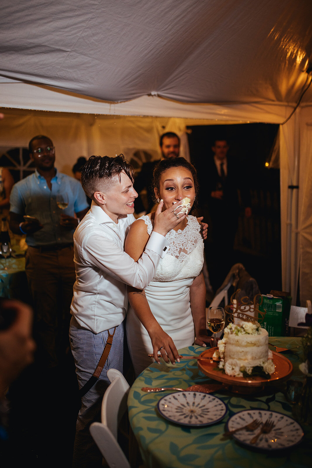Newlyweds feeding each other wedding cake in Annapolis MD Shawnee Custalow Photography