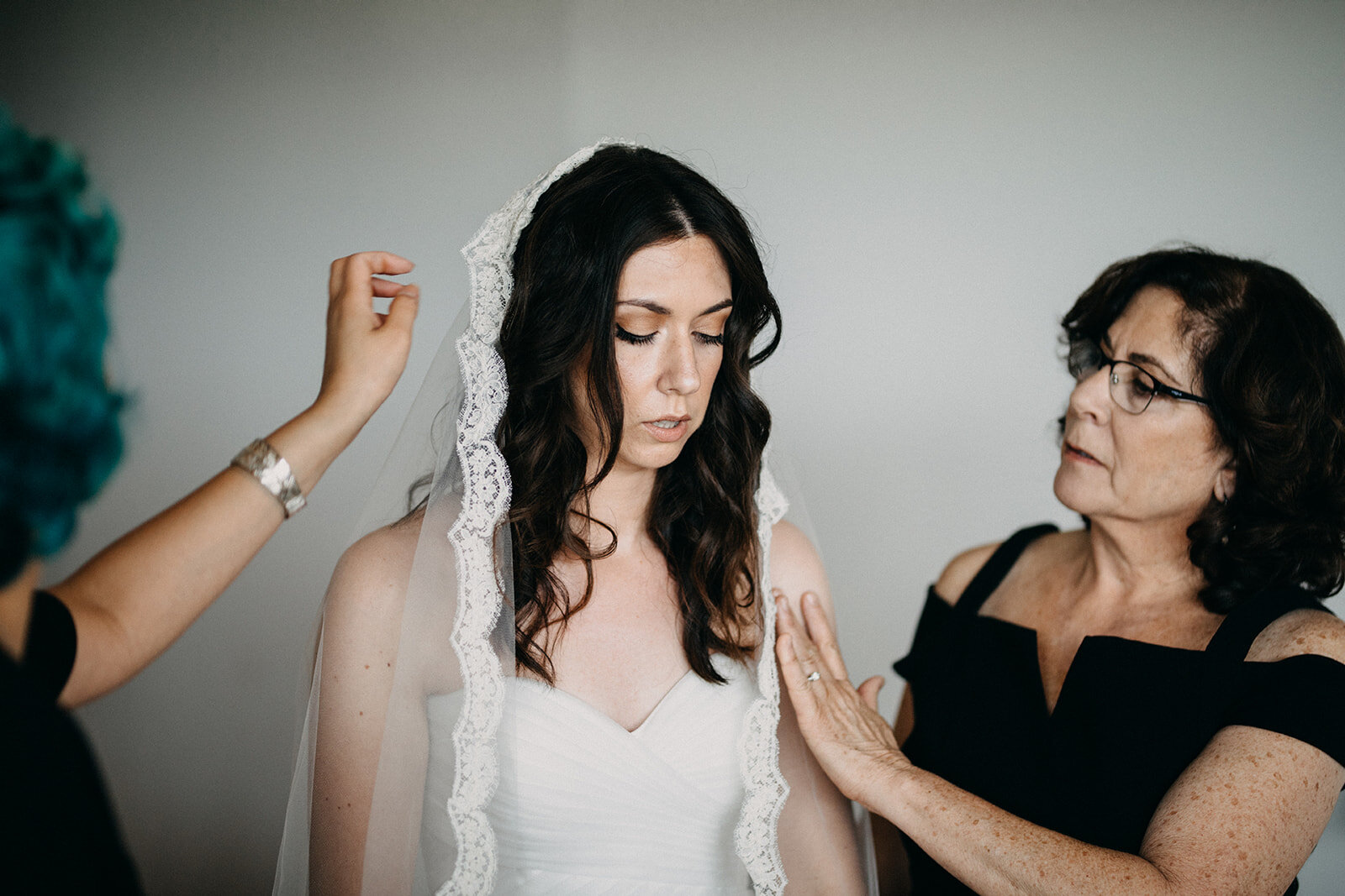 Veiled bride getting help from wedding party in Los Angeles CA Shawnee Custalow Queer Wedding Photography