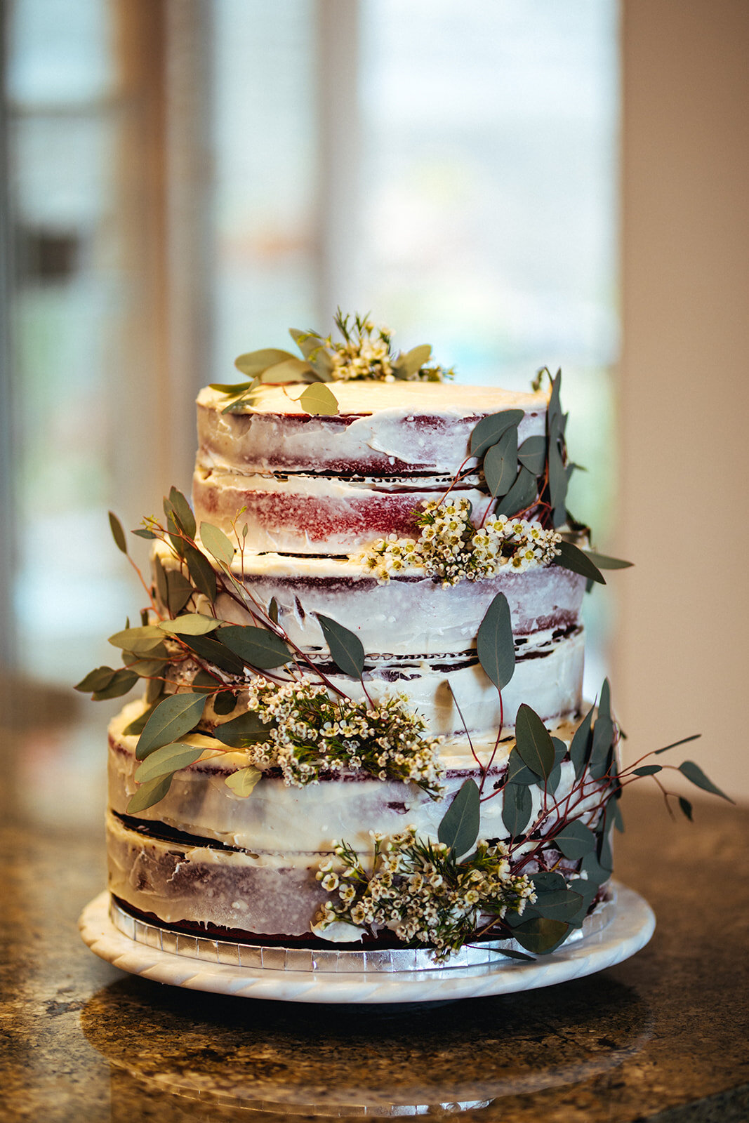 Red velvet wedding cake with floral decoration in Studio City LA Shawnee Custalow Photography