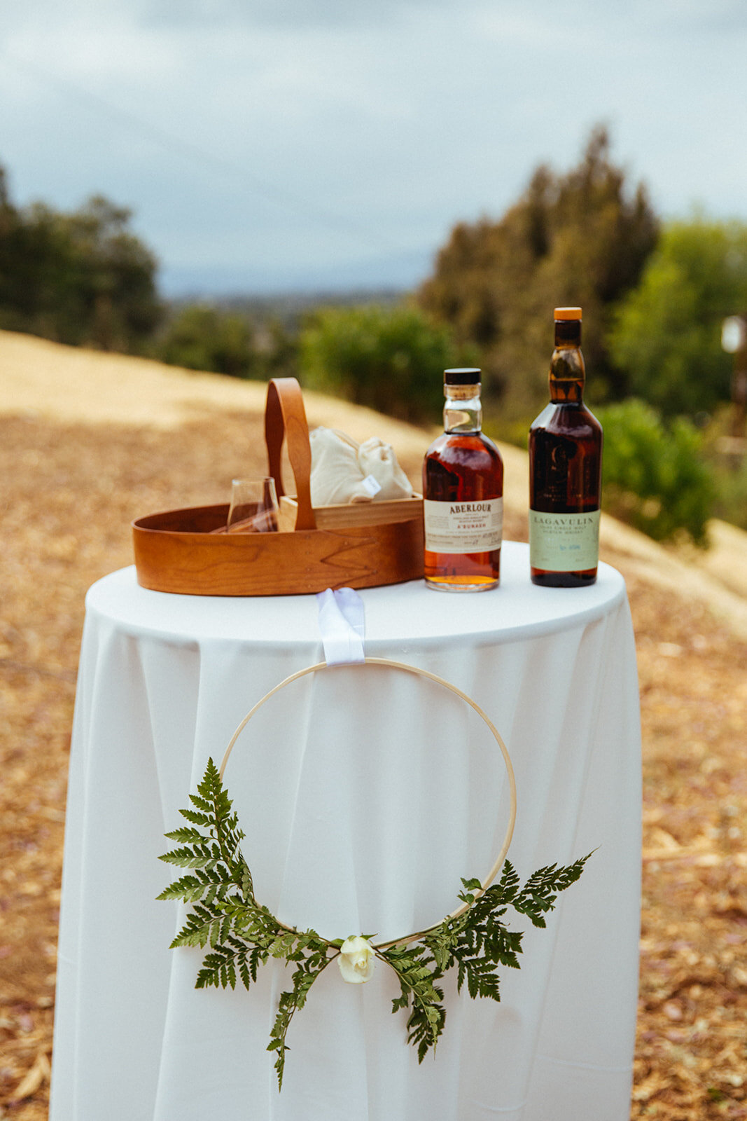 Small table set with jewish wedding ritual alcohol and cups in LA Shawnee Custalow Queer Wedding Photography