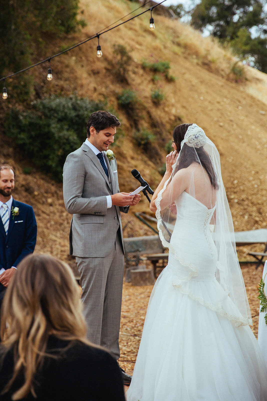 Groom reading vows during backyard ceremony in Studio City LA Shawnee Custalow Queer Wedding Photography