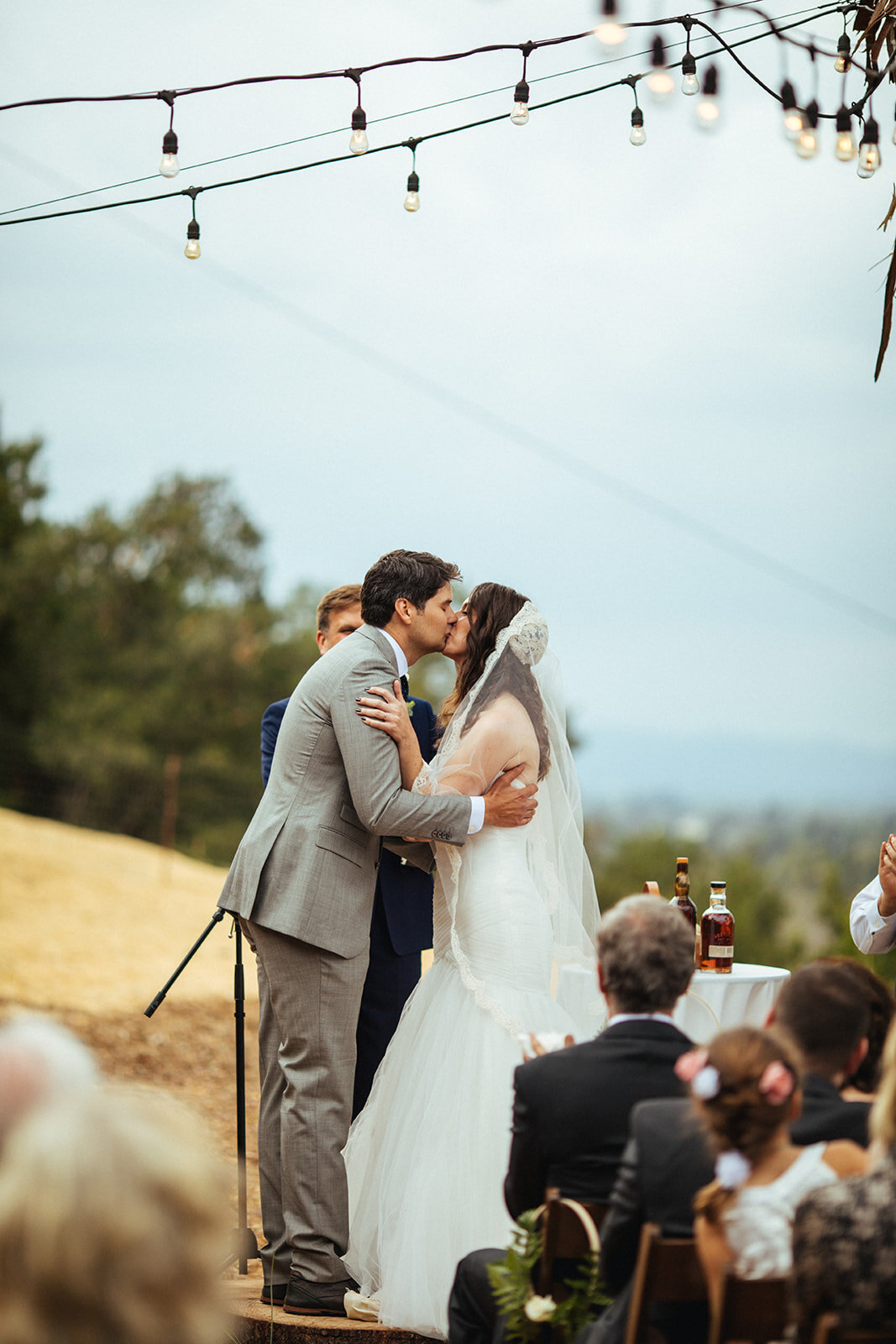 Bride and groom kiss during backyard ceremony in Los Angeles Shawnee Custalow Queer Wedding Photography