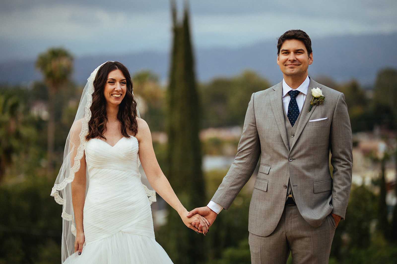 Newly married bride and groom holding hands in LA Shawnee Custalow Queer Wedding Photography
