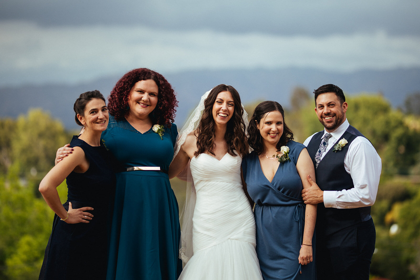 Bride posing with wedding party outside in LA Shawnee Custalow Queer Wedding Photography