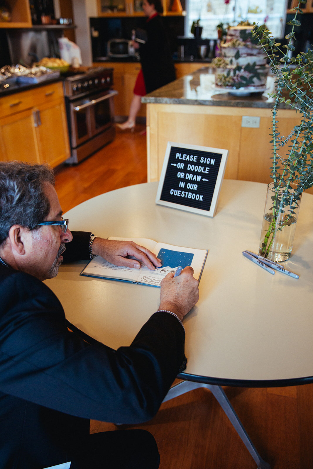 Guest signing wedding guestbook in Studio City LA Shawnee Custalow Queer Wedding Photography