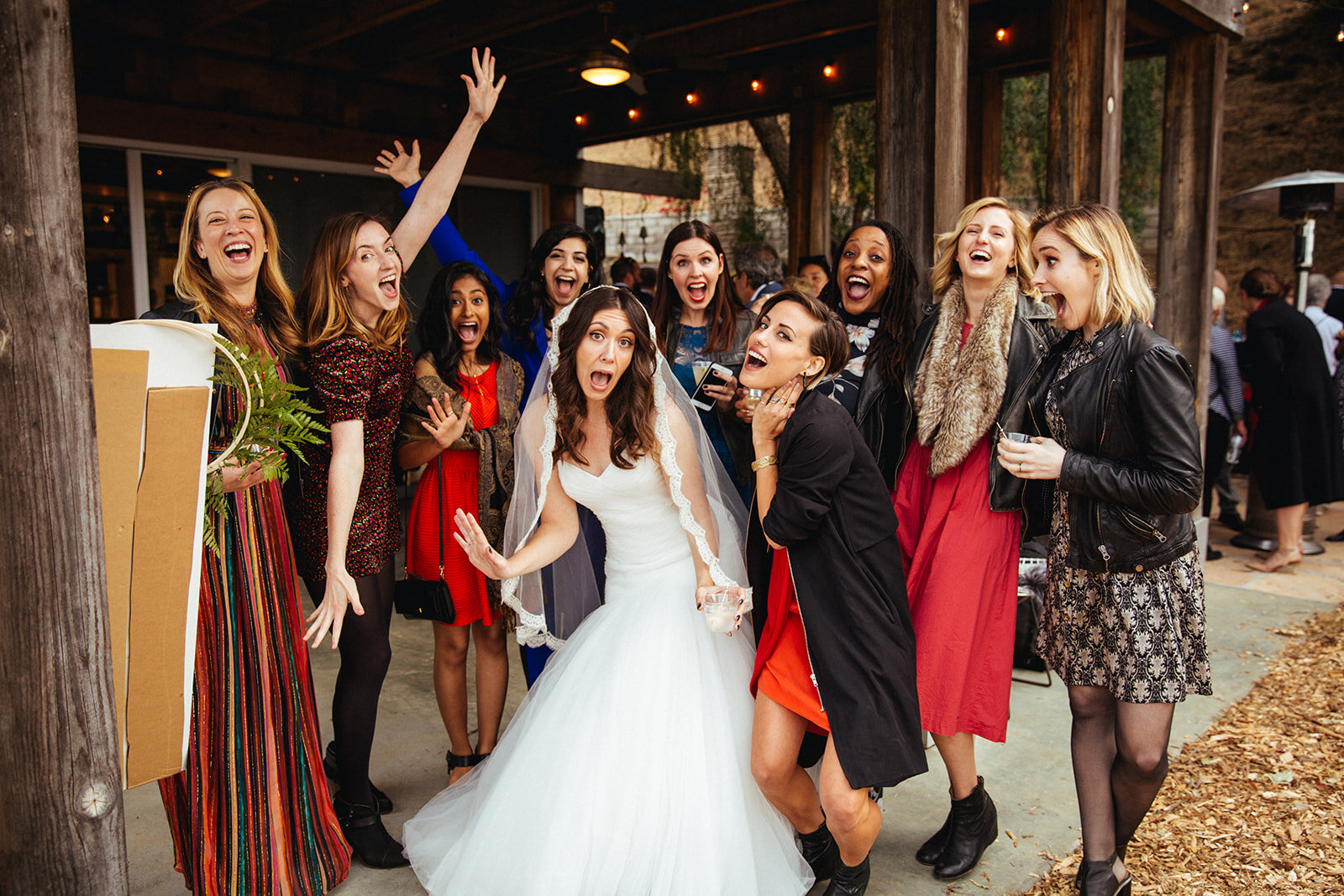 Bride posing silly with wedding guests in backyard reception in LA Shawnee Custalow Photography