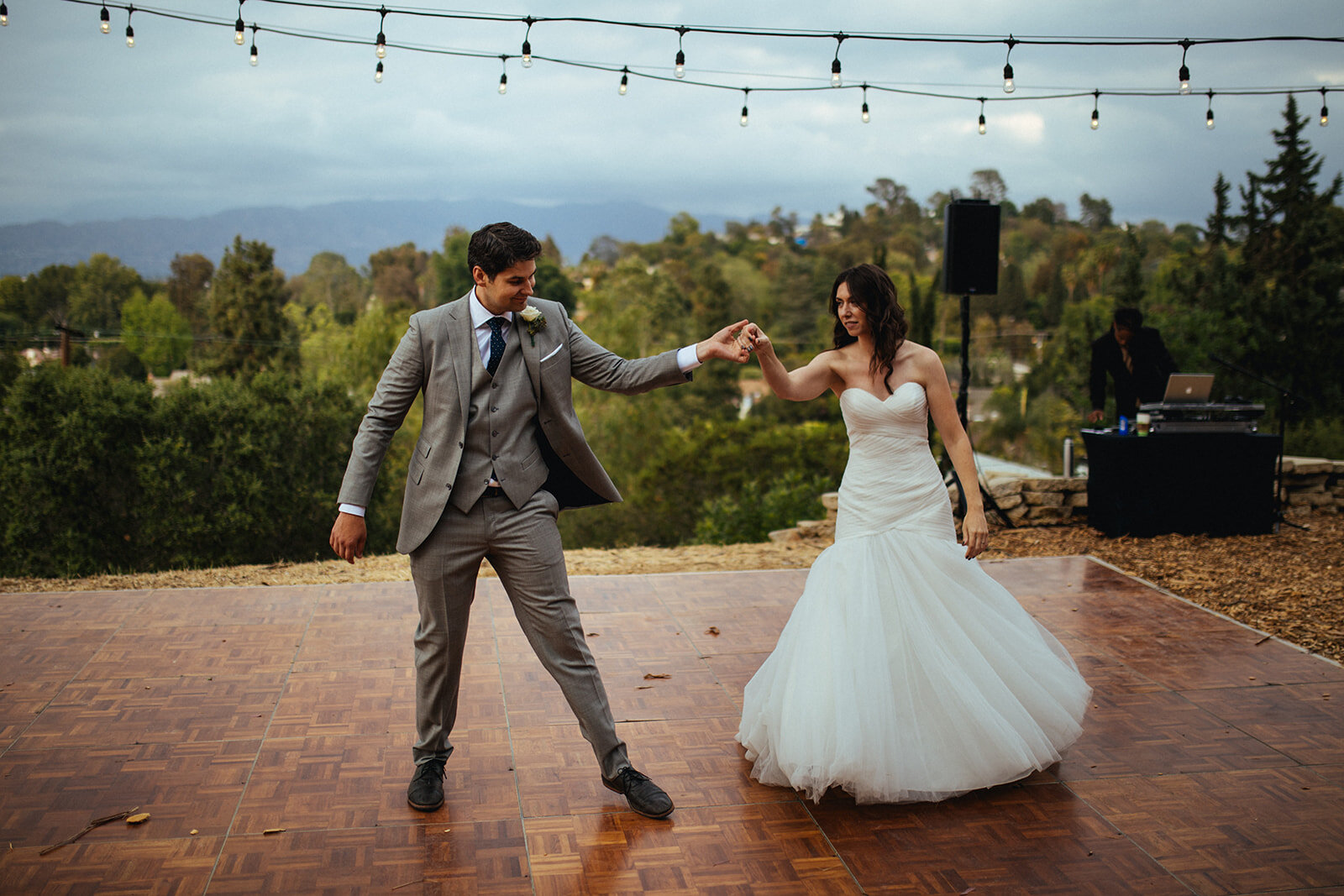 Newlyweds having first dance outside in LA California Shawnee Custalow Queer Wedding Photography