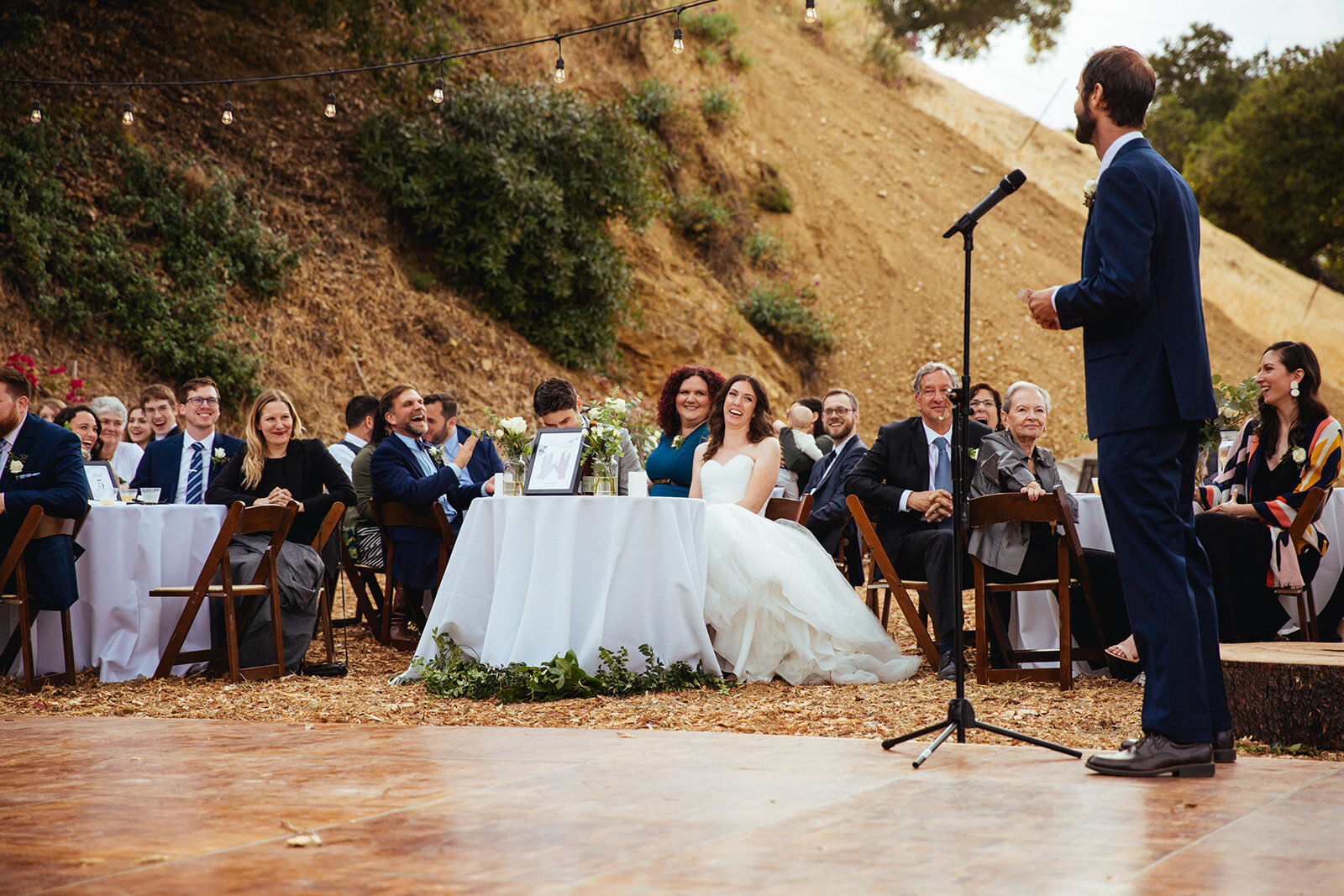 Groomsman giving a speech at LA backyard wedding reception Shawnee Custalow Queer Wedding Photography