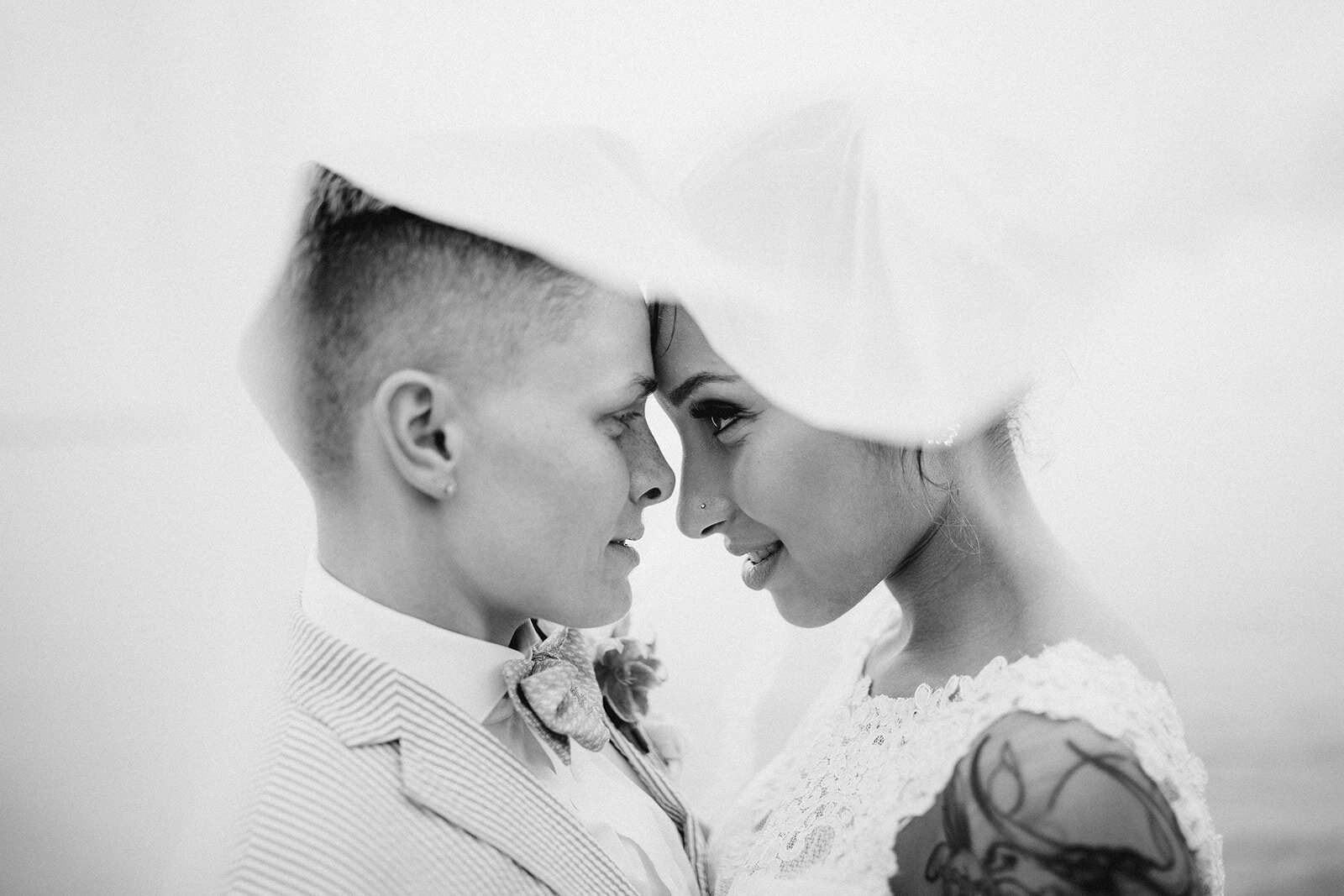 Newly married lgbtq couple under a veil in Annapolis MD Shawnee Custalow photography