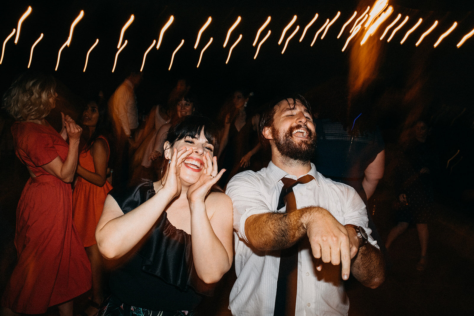 Wedding guests dancing at outdoor reception in LA Shawnee Custalow Queer Wedding Photography