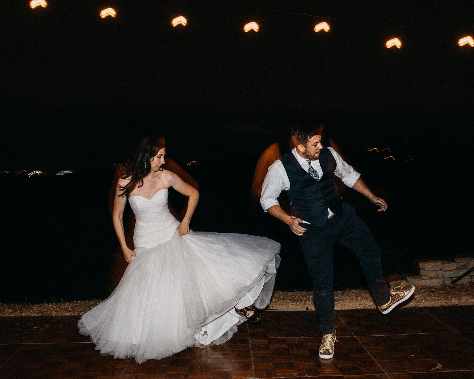 Bride and guest dancing at outdoor reception in LA Shawnee Custalow Queer Wedding Photography