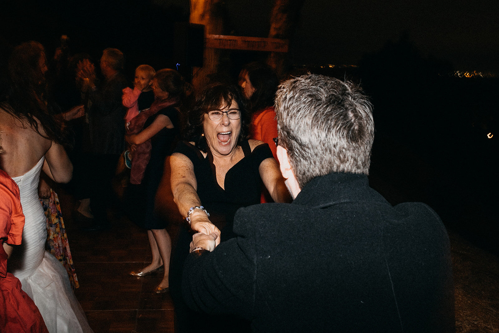 Wedding guests dancing at outdoor reception in LA Shawnee Custalow Queer Wedding Photography