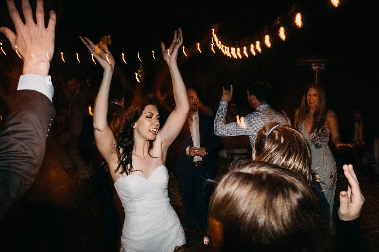 Bride dancing with wedding guests at outdoor reception in LA Shawnee Custalow Queer Wedding Photography