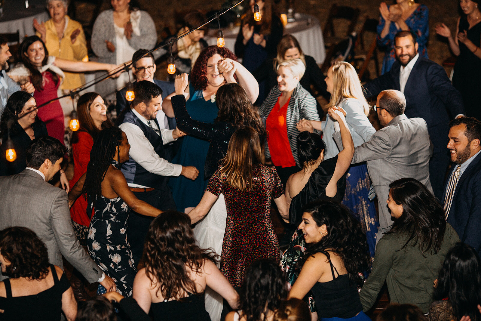 Bride and groom dancing the Hora with guests at reception LA Shawnee Custalow Queer Wedding Photography