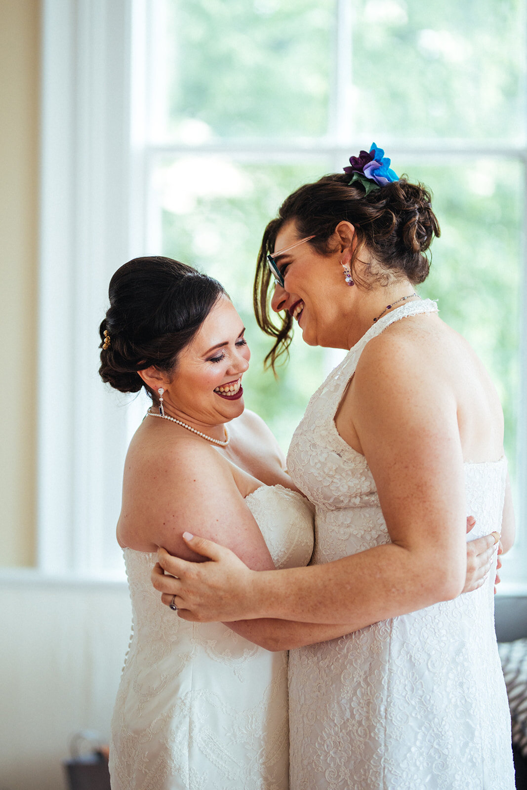 Future spouses embracing before ceremony at Torpedo Factory Virginia Shawnee Custalow Queer Wedding Photography