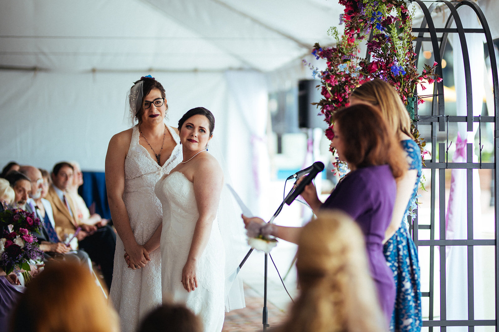 Brides watching guests speak at their wedding in Alexandra VA Shawnee Custalow Photography