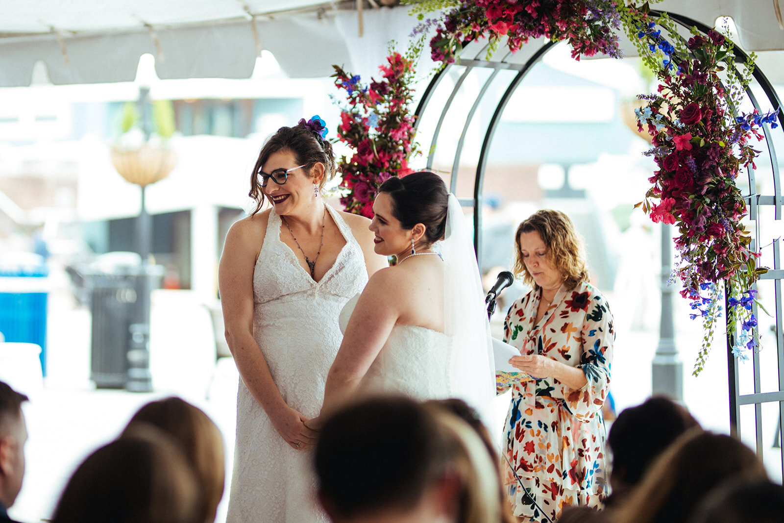 Brides smiling at their guests during ceremony at Torpedo Factory VA Shawnee Custalow Photography