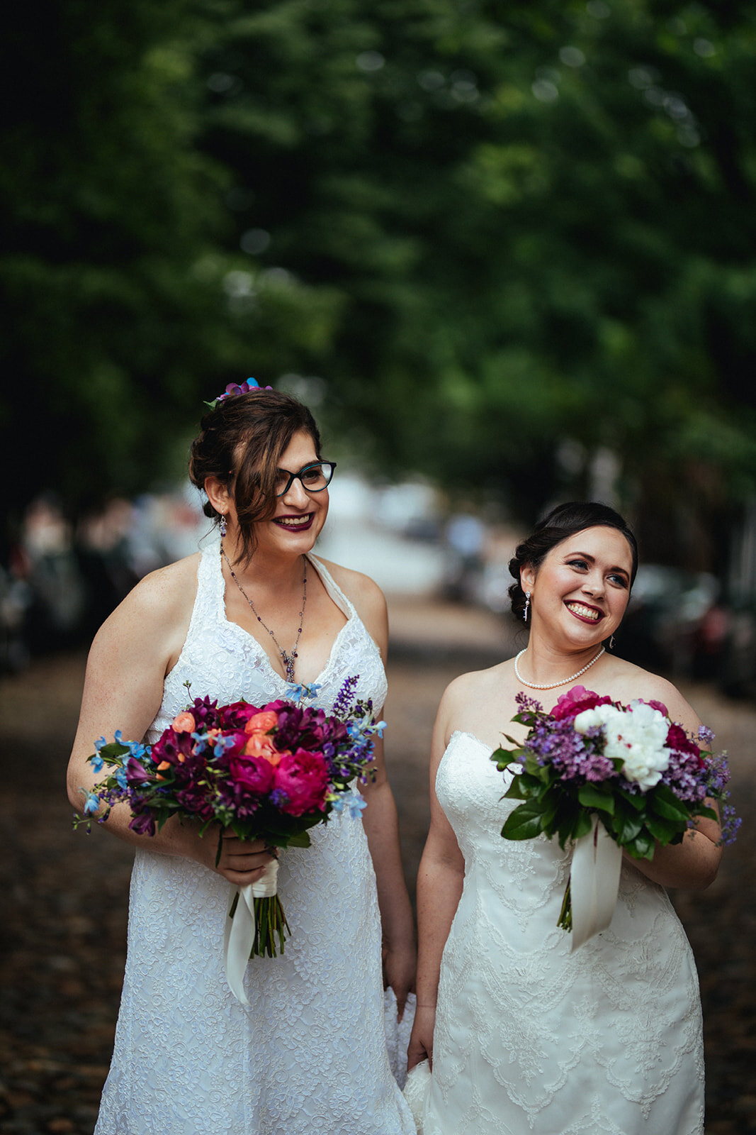 Newly married brides smiling outside in Alexandria VA Shawnee Custalow Wedding Photographer