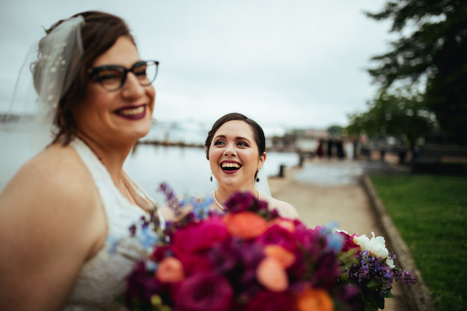 Newlywed LGBTQ couple smiling in Alexandria VA Newlywed brides leaning in for a kiss in Alexandria VA Shawnee Custalow Wedding Photographer