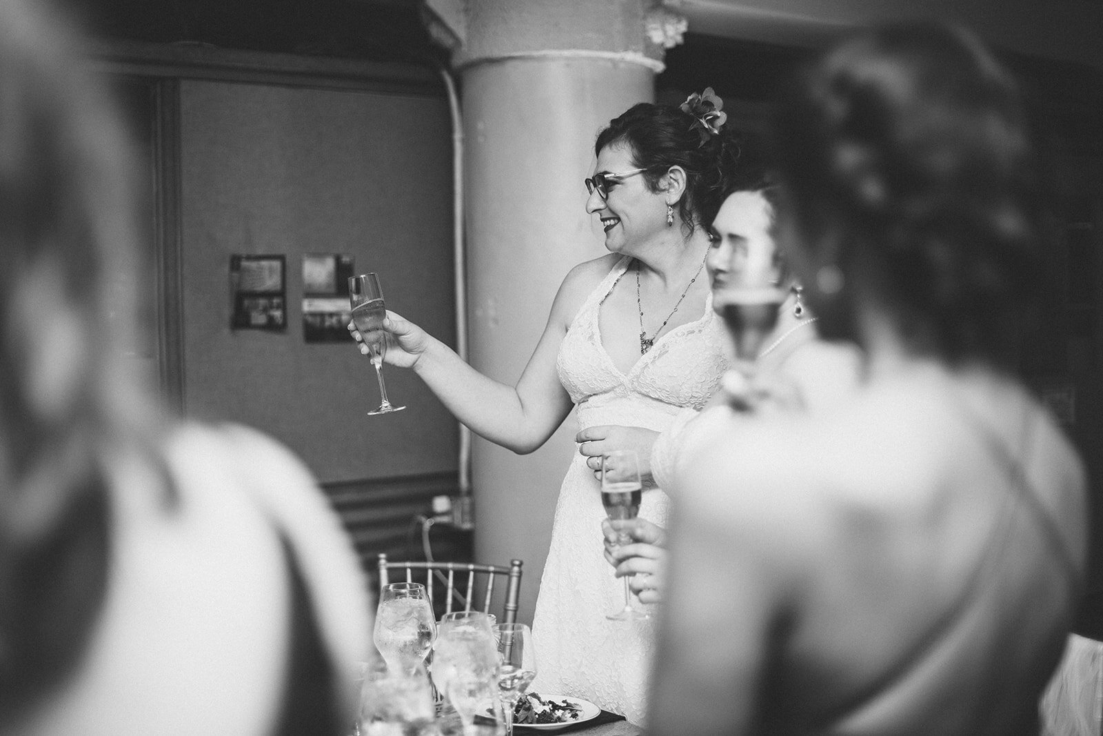 Newlyweds raising a toast at their reception at Torpedo Factory Alexandria VA Shawnee Custalow