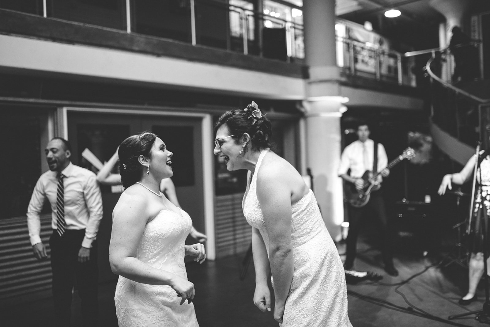 Newlywed queer couple laughing at Torpedo Factory Alexandria VA Shawnee Custalow Queer Wedding Photography