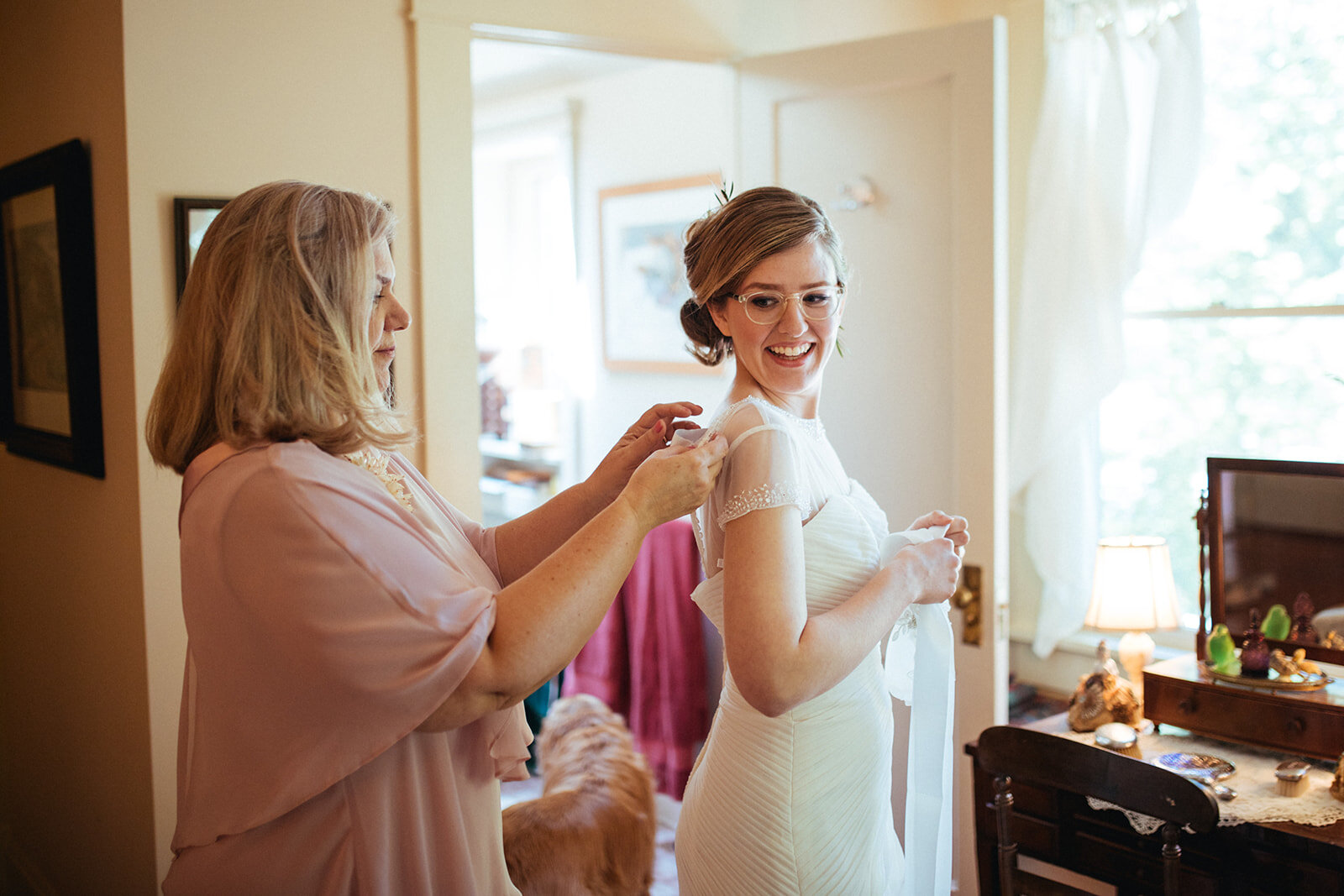 Mother helping daughter with her wedding dress in ATL Shawnee Custalow Wedding Photographer