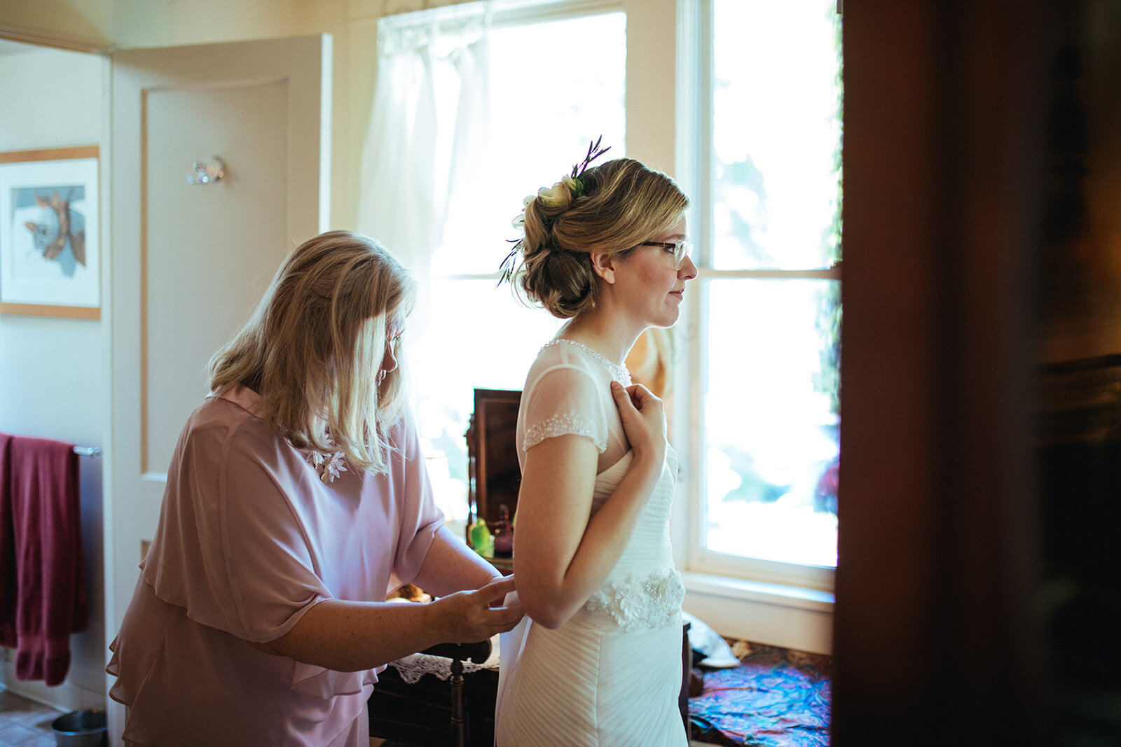 Mother helping daughter into wedding dress in Atlanta GA Shawnee Custalow Queer Wedding Photographer