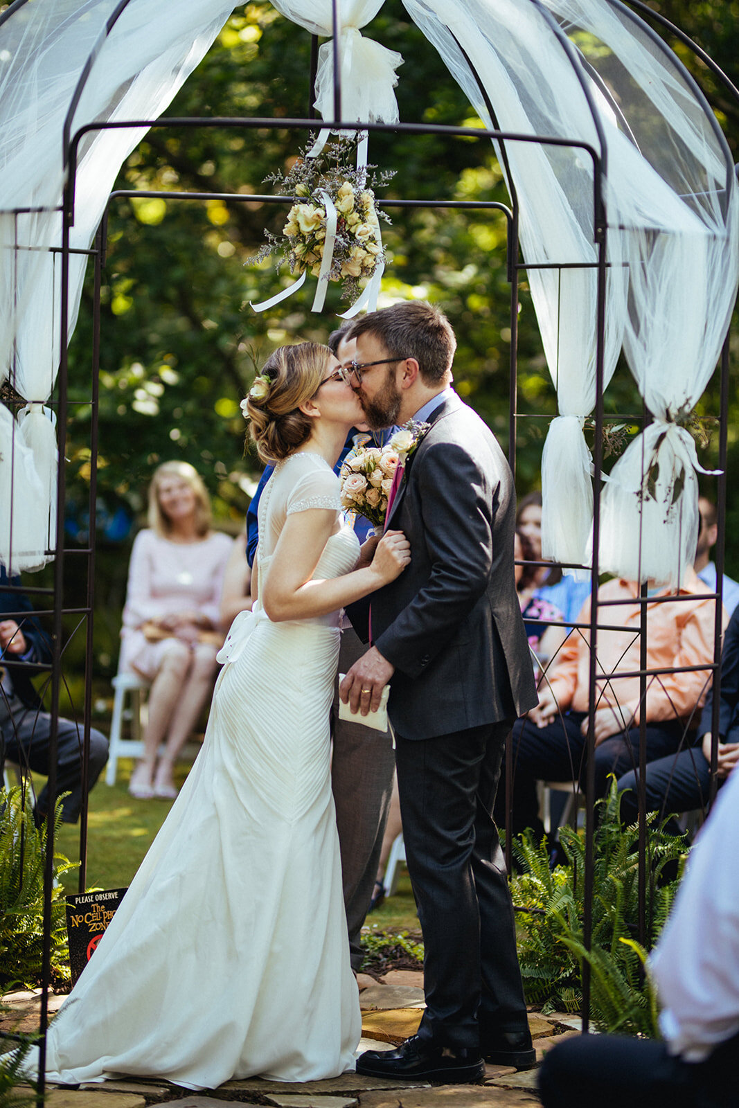 Newly married couple kissing at their wedding in Atlanta GA Shawnee Custalow Queer Wedding Photographer