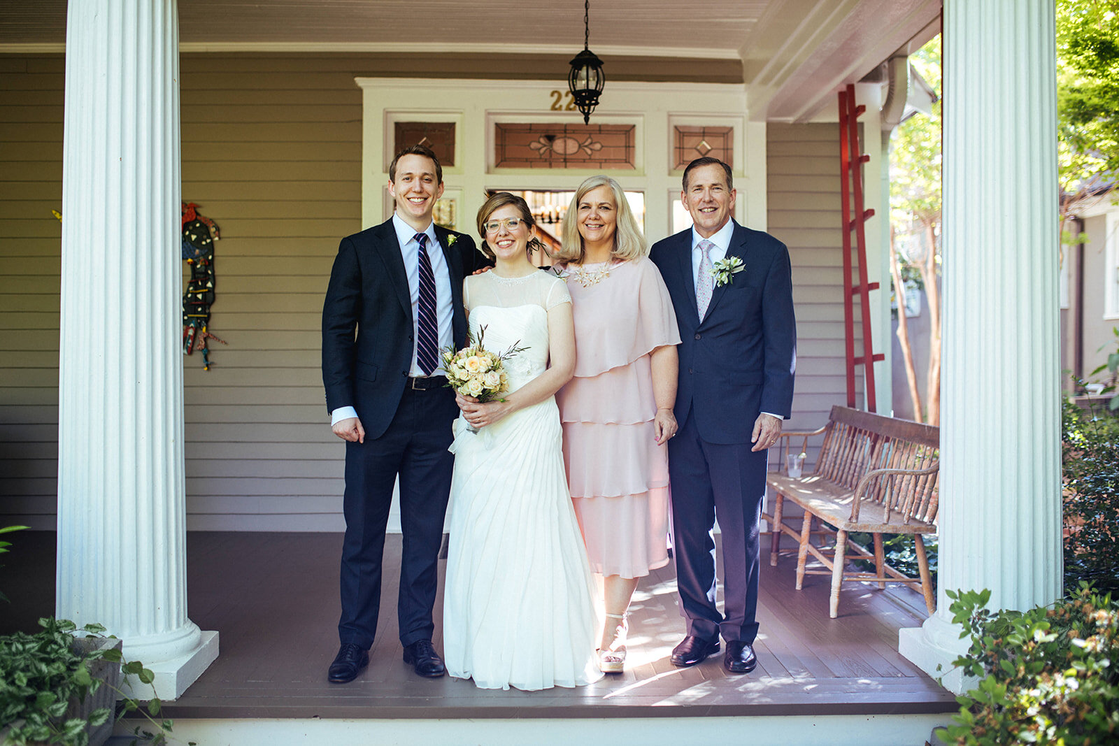 Bride posing with family at home in Atlanta GA Shawnee Custalow Queer Wedding Photographer