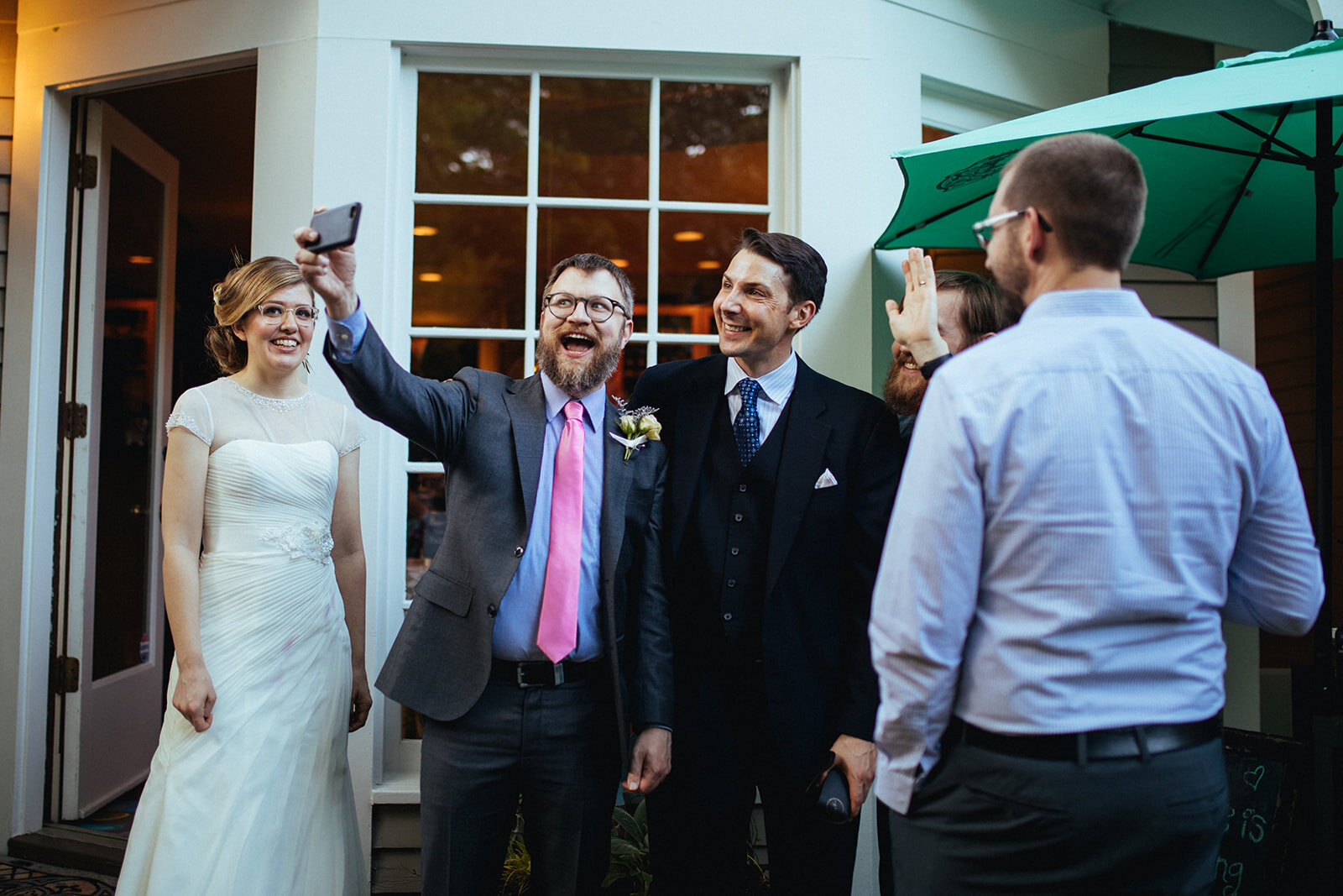Bride and groom taking a group selfie with guests in Atlanta GA Shawnee Custalow Wedding Photographer
