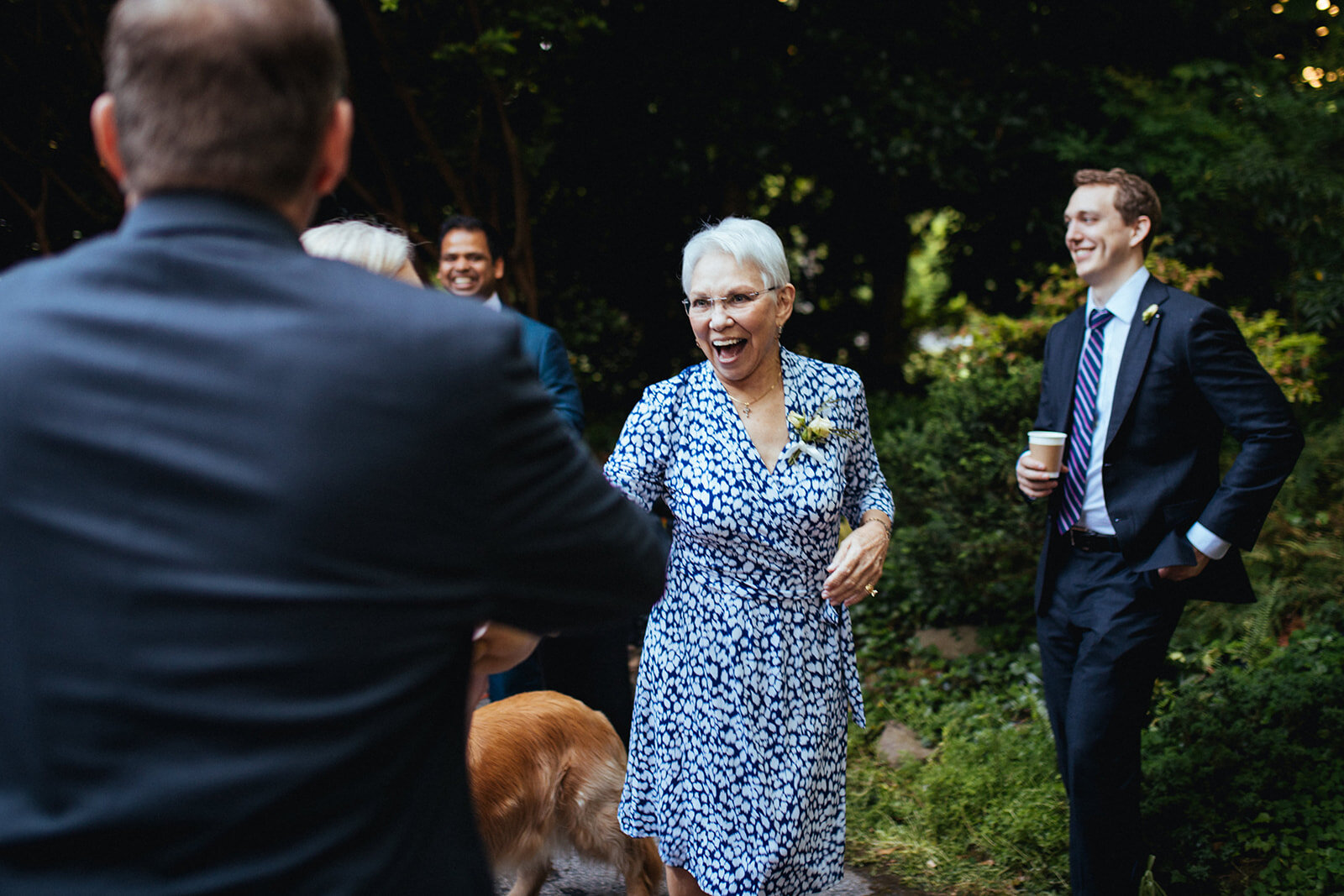 Guests mingling at backyard reception in Atlanta GA Shawnee Custalow Queer Wedding Photographer