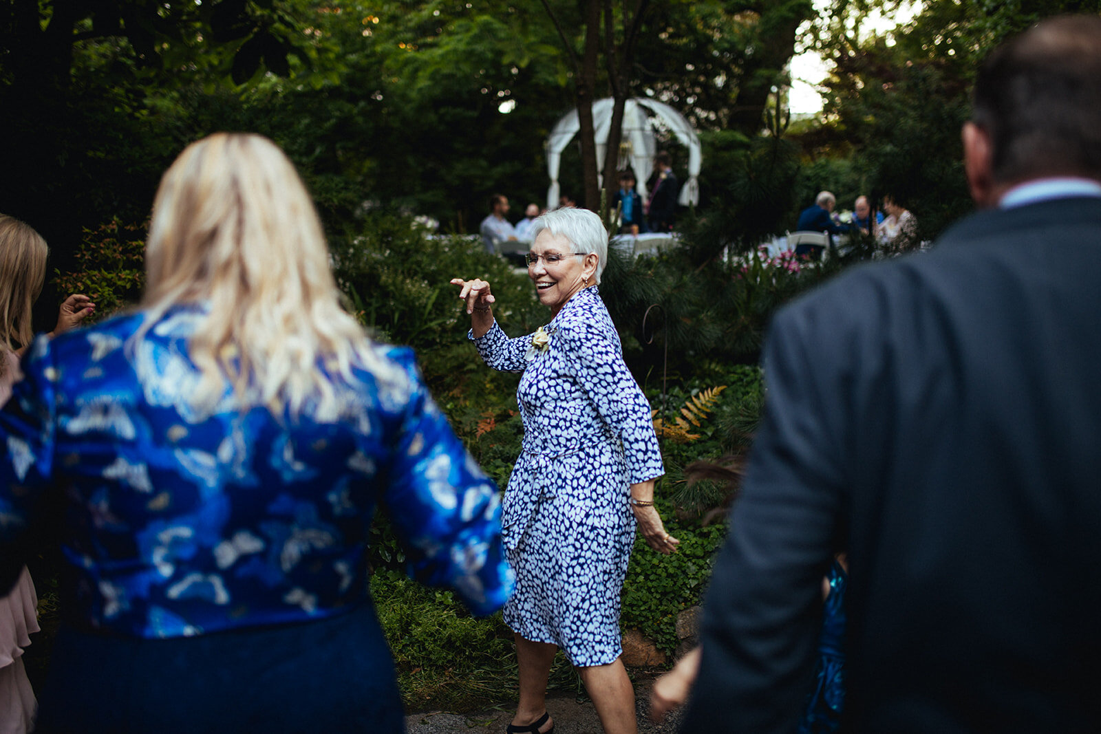 Guests dancing at backyard reception in ATL Shawnee Custalow Queer Wedding Photographer