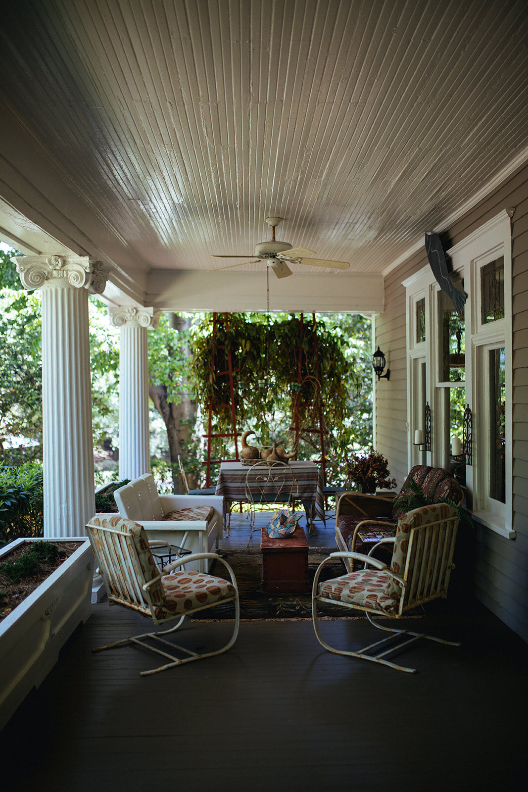 Porch decorated with old outdoor furniture in ATL Shawnee Custalow Queer Wedding Photographer