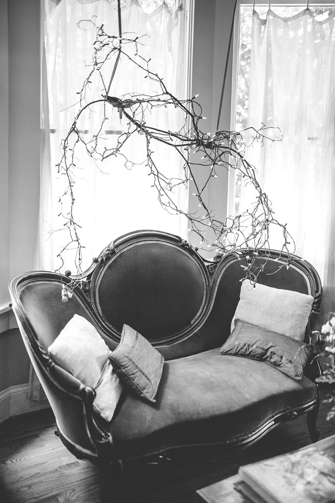 Antique couch with christmas lights hanging above in Atlanta Shawnee Custalow Wedding Photographer
