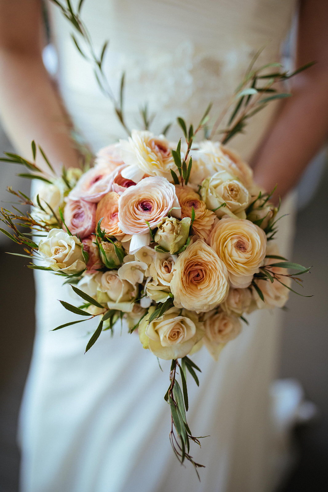 Bride holding soft pink bouquet of roses in Atlanta GA Shawnee Custalow Queer Wedding Photographer
