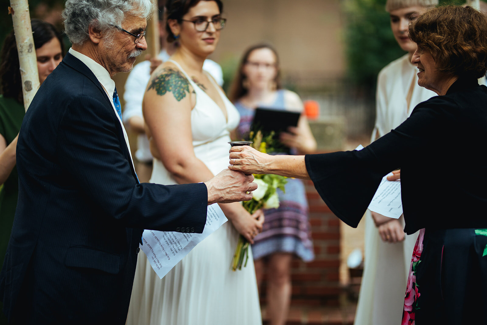 Honor attendants passing ritual wine cup at LGBTQ Jewish Wedding in Philly Shawnee Custalow Photography