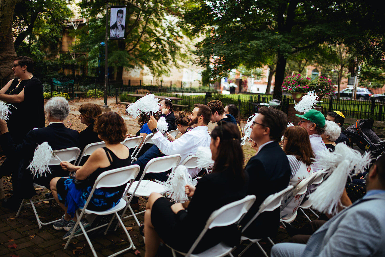 Guests waiving pompoms for the newlyweds outside in Philadelphia Shawnee Custalow Queer Wedding photography