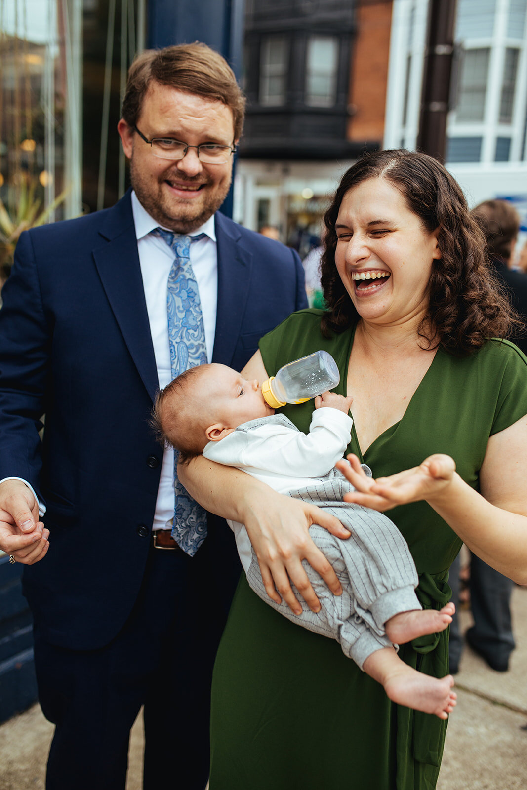 Wedding guests laughing with an infant in Philadelphia PA Shawnee Custalow Queer Wedding photography
