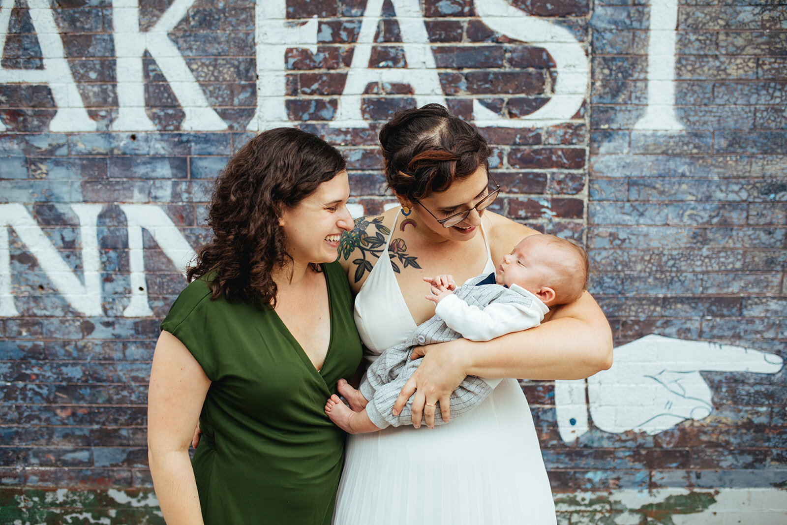 Newlywed with guests and holding an infant in Philly Shawnee Custalow Queer Wedding photography