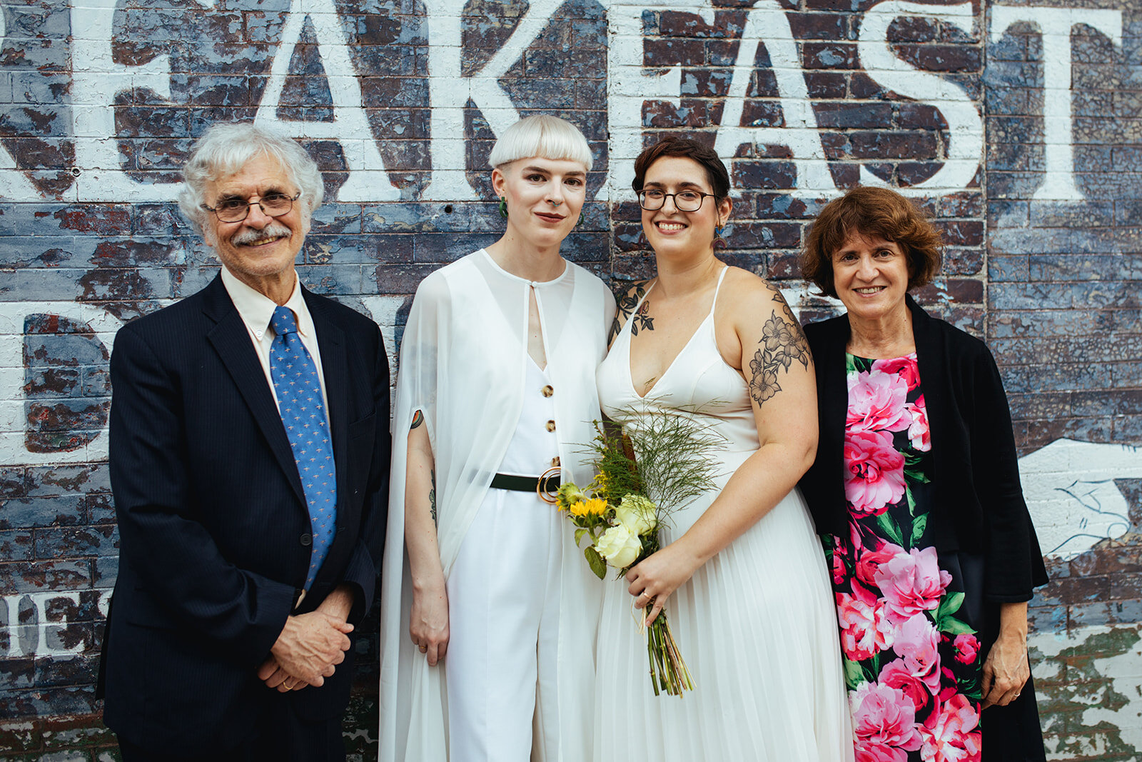 Newly married LGBTQ couple posing with family in Philadelphia Shawnee Custalow Queer Wedding photography